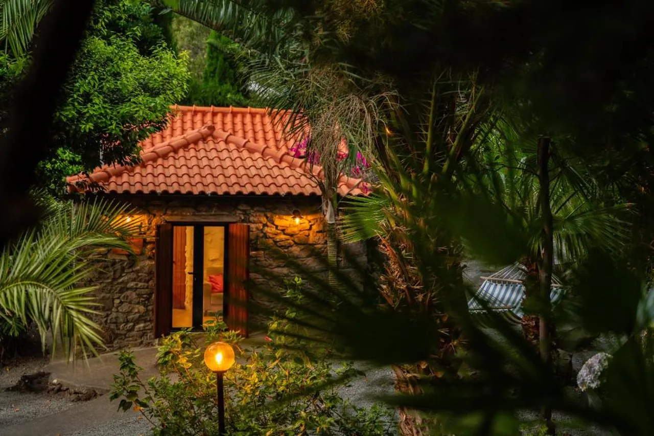 Stenen huisje met terracotta dak tussen subtropische tuinen op Madeira